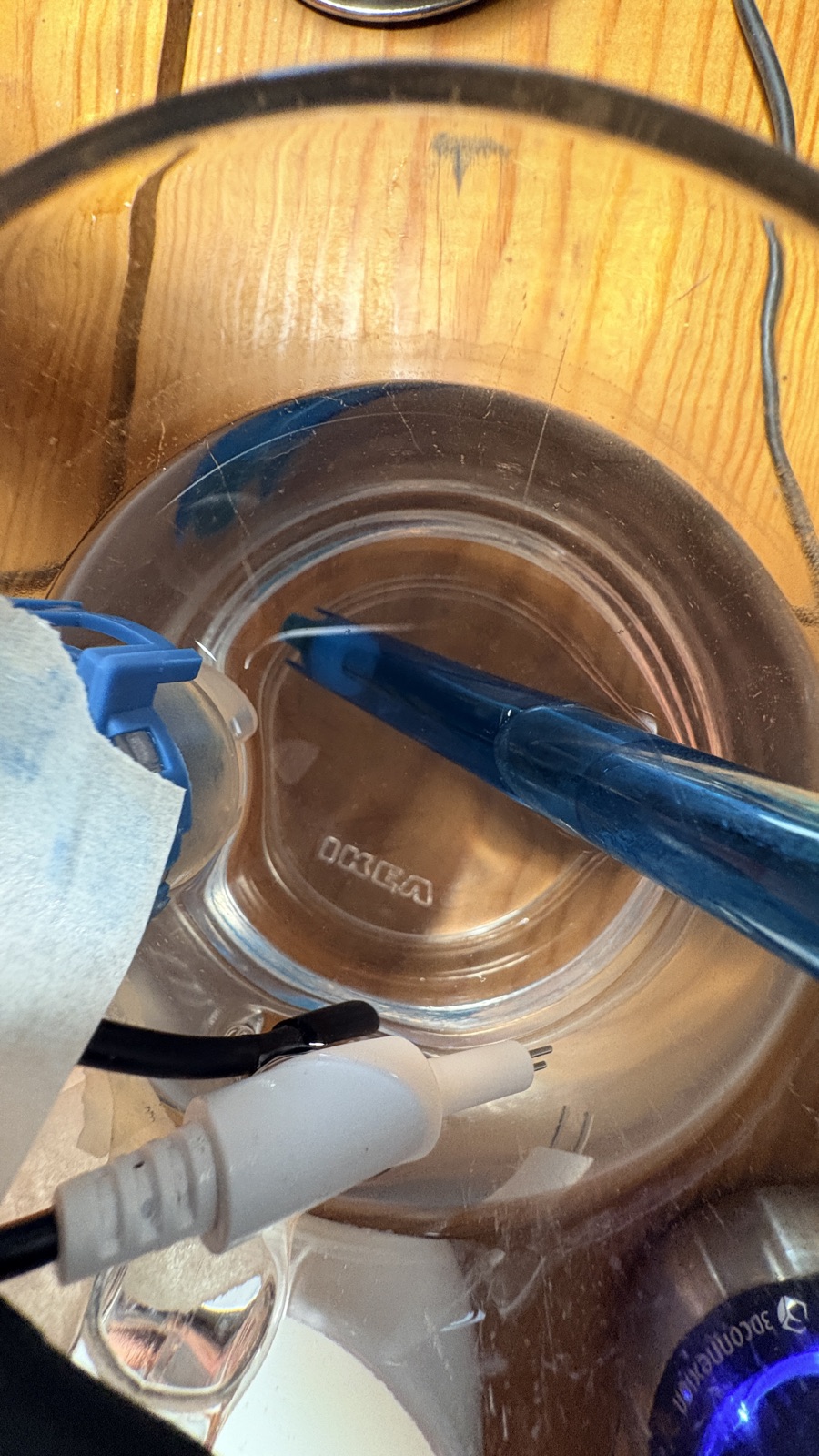WellBouy probes (DS18B20 temperature, TDS, turbidity, pH) dipped into a mug of water during bench calibration